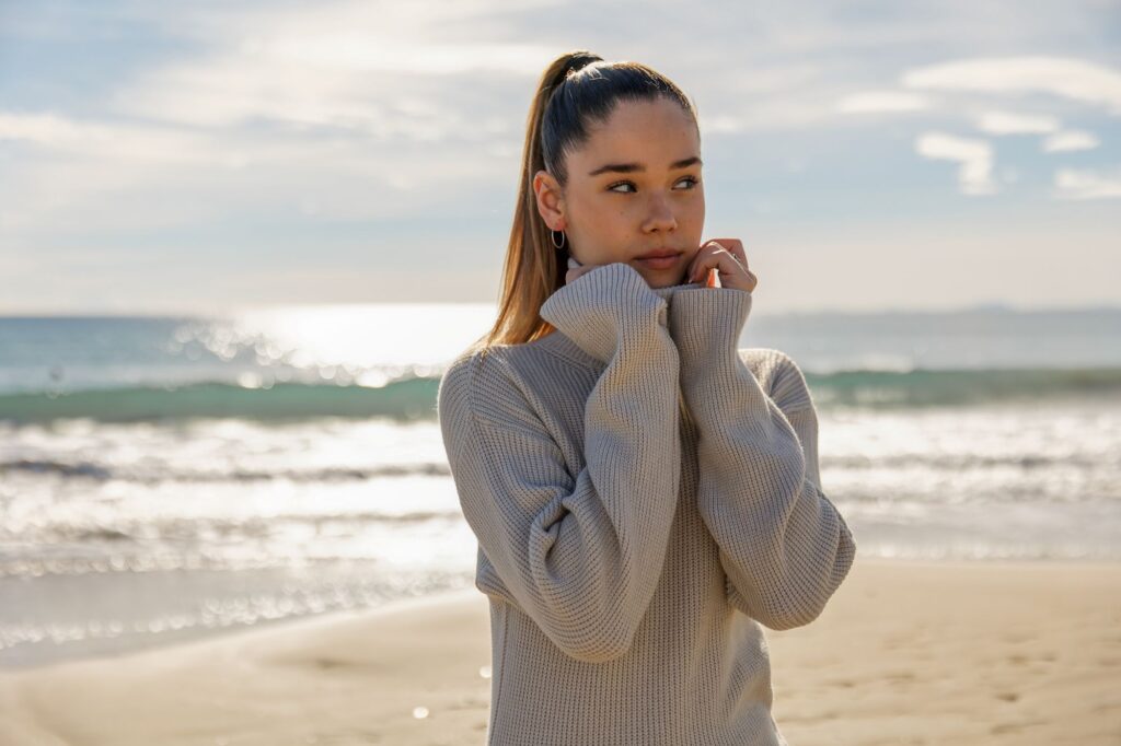 portrait of a young pretty girl with the beach in the background
