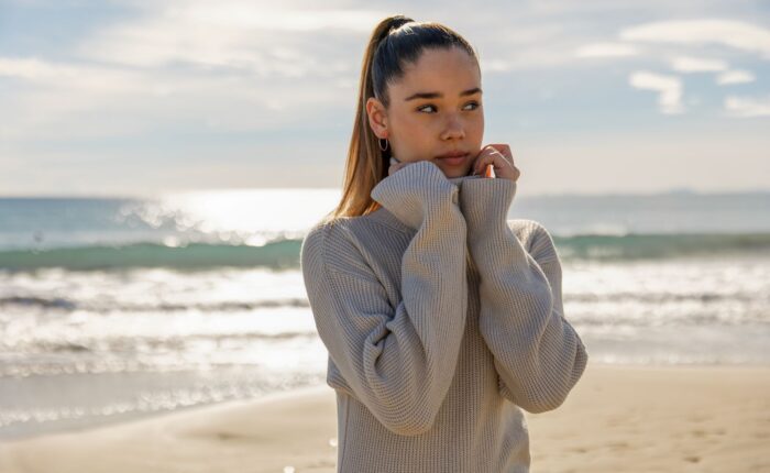portrait of a young pretty girl with the beach in the background